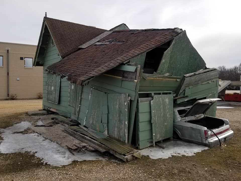 A car under a collapsed house