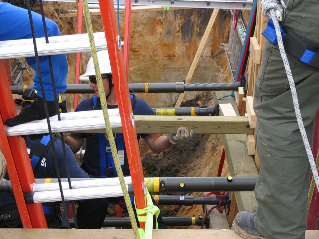 Installing Trench Shores to avoid cave ins